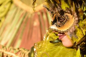 girl in a green mask at the carnival in Venice