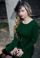 blonde with makeup in vintage green dress