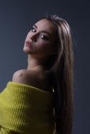 Beautiful girl in yellow clothing, looking behind