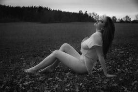 black and white photo of a girl on the field