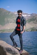 stylish young man posing on the coast
