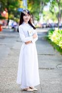 Asian woman in white posing in the park