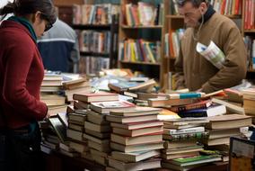 stacks of books on the table in the market