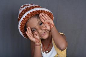 Portrait of the black-skinned girl, with the beautiful drawings on the hands