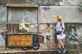 woman standing near the wall with graffiti