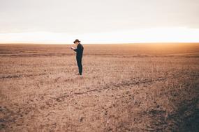 Man Guy on Dried grass at sunset