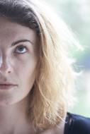 young Woman looking up, half face portrait