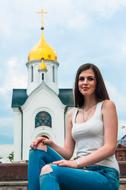 photo of a girl on the background of the Orthodox Church