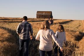 People on the beautiful and colorful landscape with the house on the field, in sunlight