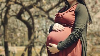 pregnant Woman in red dress outdoor