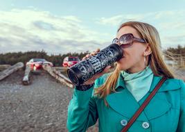 girl with thermos outdoors