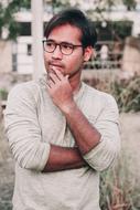 portrait of a sad man with glasses on the street