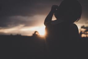 silhouette of a woman in the dark twilight