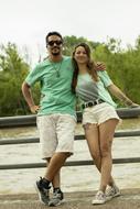 happy caucasian couple posing on waterside