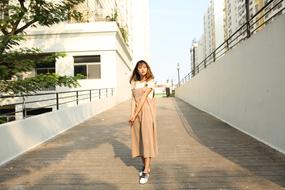 fashionable stylish girl posing among city buildings