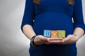 boy, Alphabet Blocks on pregnant woman Hands