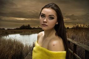 photo of a girl on a bridge near the river