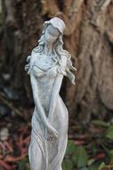 statue of a shy girl in the garden