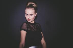 stylish girl with hairstyle on black backgroundnd