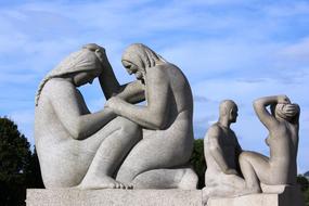 Statues of the people in Oslo, Norway, under the blue sky with clouds