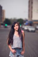 teen girl on a city street in a blurry background