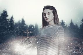 Young Woman in front of lonely christian grave