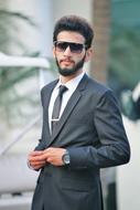 young businessman with beard on blurred background