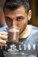 Portrait of the man drinking coffee in glass