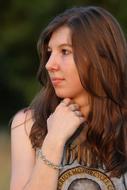 portrait of a young girl with long hair outdoors