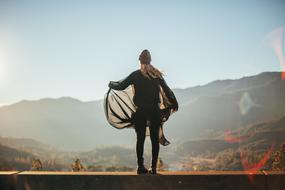 girl with a scarf on the top of the mountain