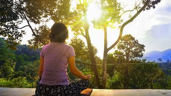 woman meditation in nature in a picturesque landscape