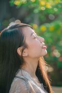 profile portrait of an asian woman on a blurred background