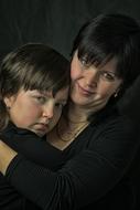 mother and daughter on a dark background