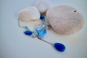 blue jewelry and white pebbles