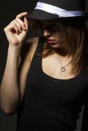 portrait of a girl in a hat in the dark