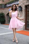 smiling asian girl in pink dress