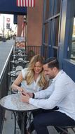 Laughing couple sitting at the table of the cafe