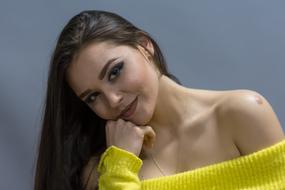 girl with makeup in a yellow sweater