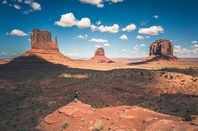 girl on the edge of the cliff on the background of the desert