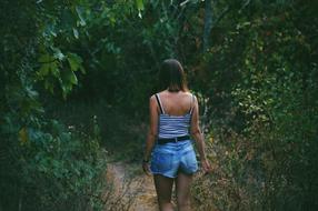 girl walking in the thickets of the forest