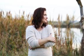 woman posing in the reeds near the lake