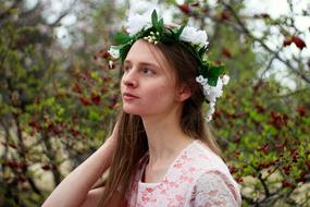 girl in a flower wreath in the garden