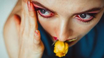 woman with yellow rose in her mouth close up