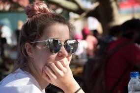 pensive girl in sunglasses on a blurred background