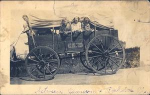 Family in Vintage Covered Wagon photo