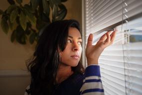 brunette near the window with blinds