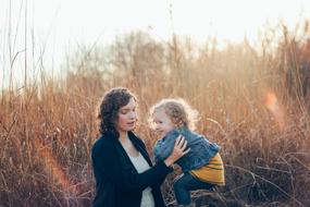 mom with curly child in nature