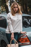 girl standing near the car on the street