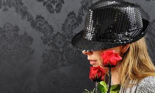 profile portrait of woman in black shiny hat