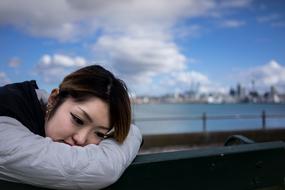 sad japanese woman against the backdrop of the cityscape